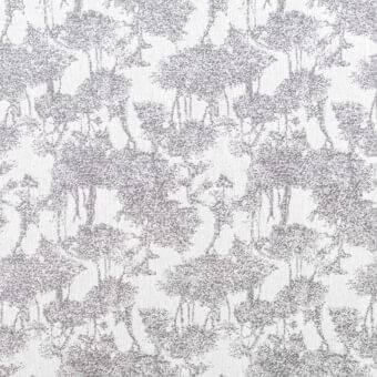 Grayscale floral pattern with textured, pointillist effect; abstracted blooms and delicate elements on a solid gray background, resembling decorative textile.